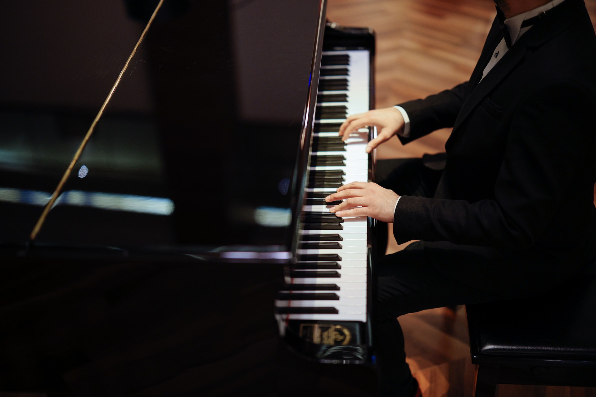 Man Playing Piano with Dramatic Lighting