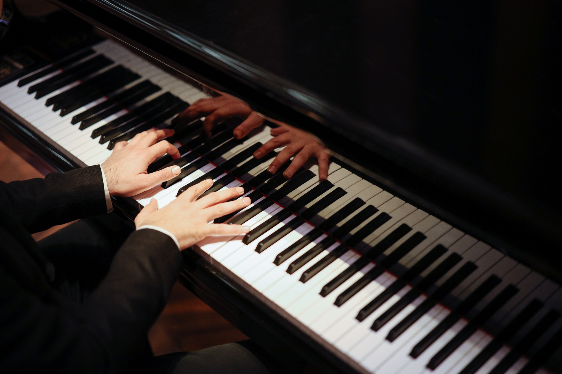 Man Playing Piano with Dramatic Lighting