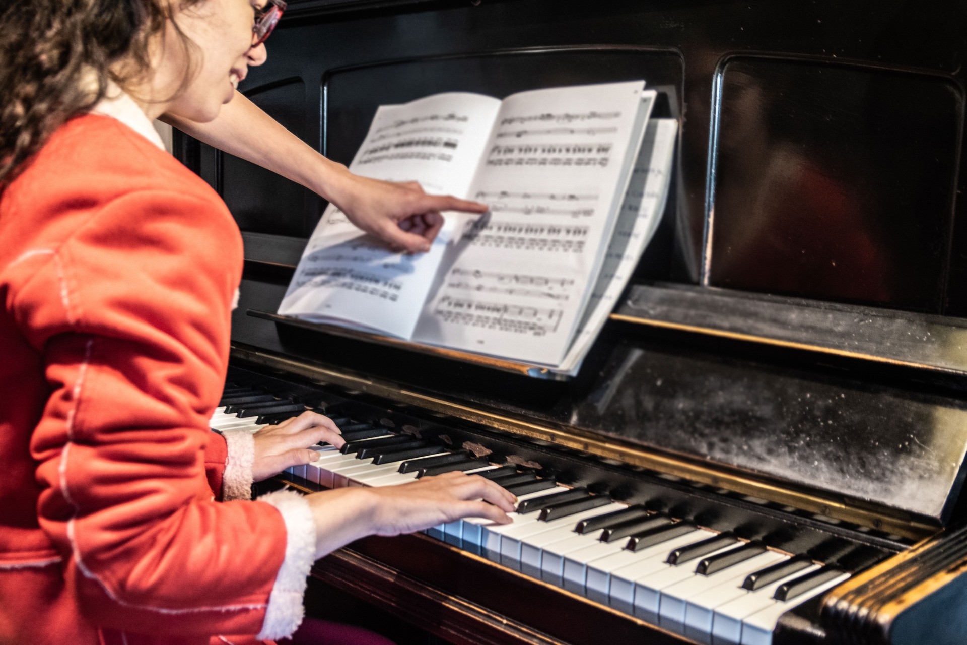 Young woman during piano lesson at home